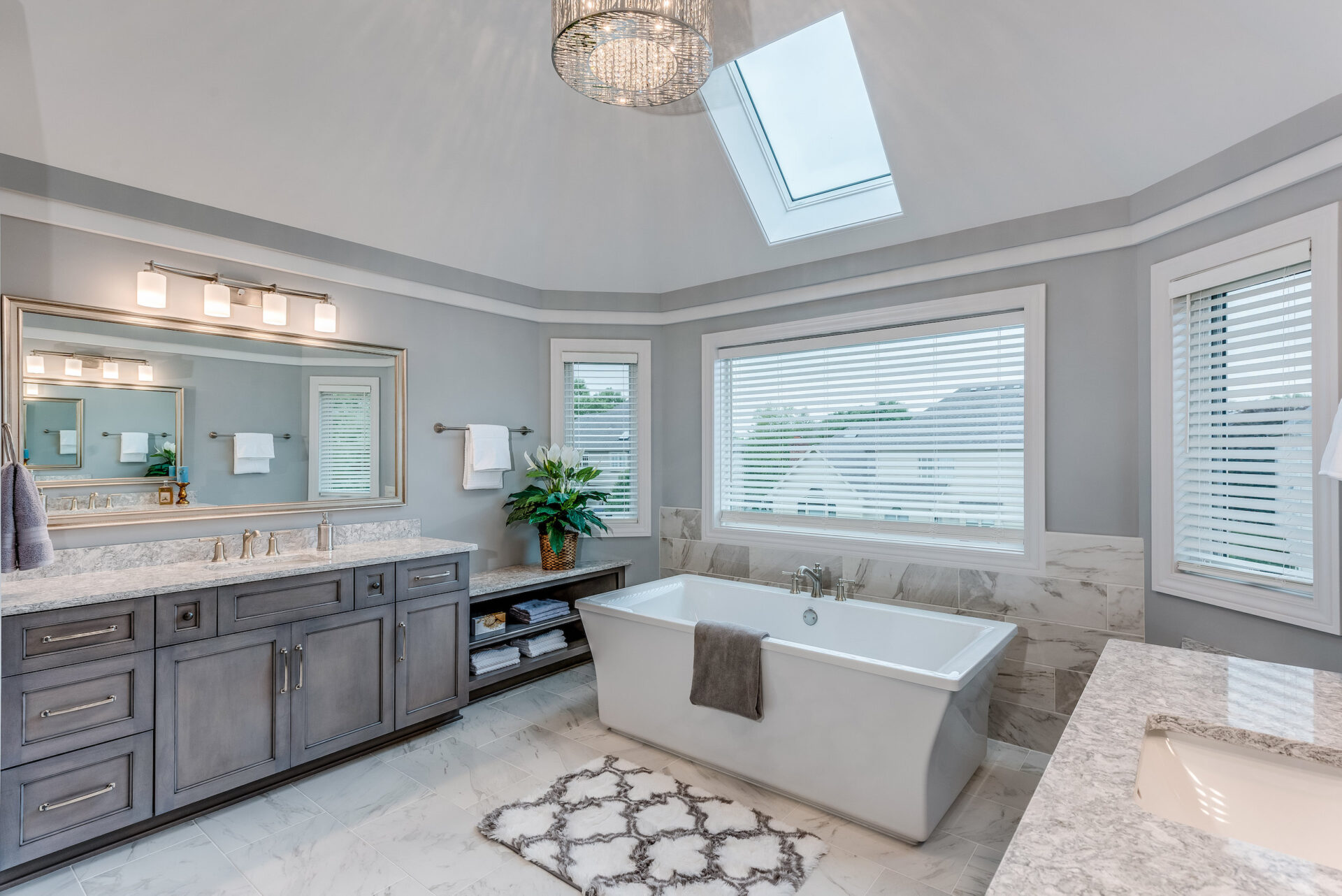 Bathroom master suite with large freestanding tub and skylight window